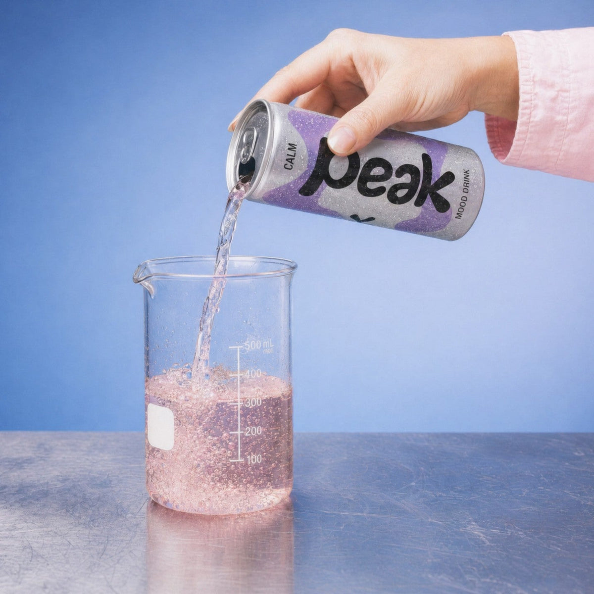 A can of Peak Calm poured into a glass beaker