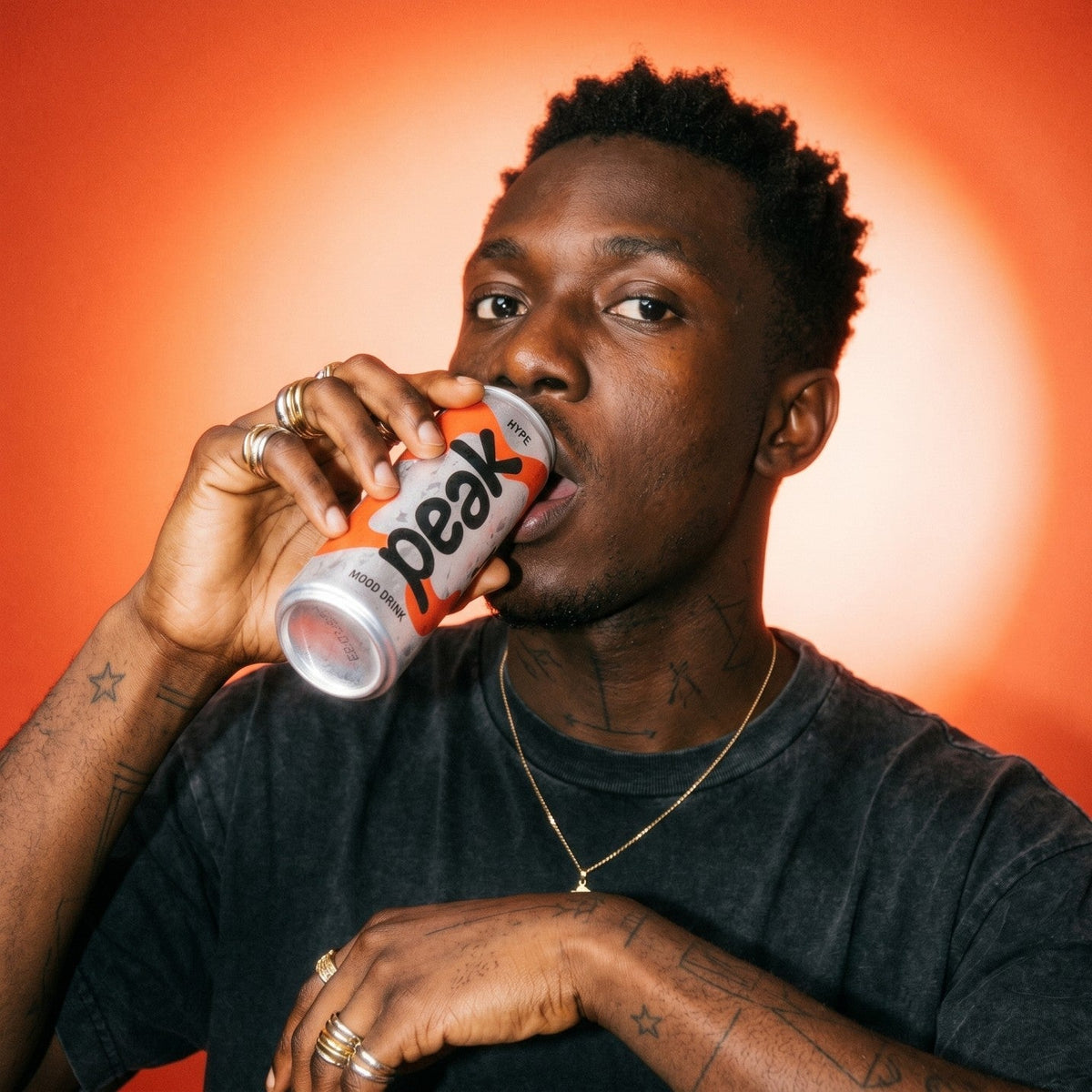 A man drinking a can of Peak Hype